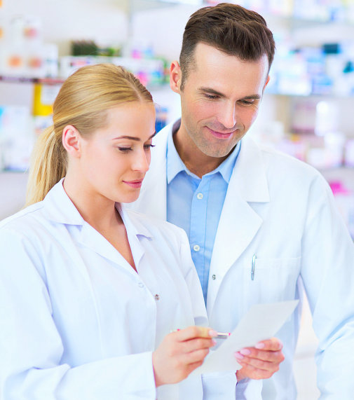 two pharmacists reviewed the prescription while smiling